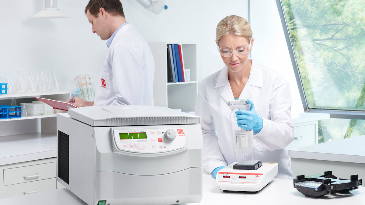 White laboratory centrifuge with digital display and control panel