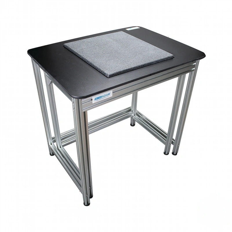 Black desktop with silver metal frame and gray textured mat on top