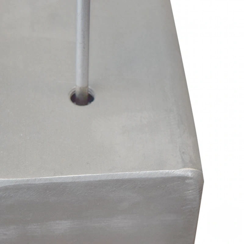 Silver metallic cube with a cylindrical rod inserted through its center hole