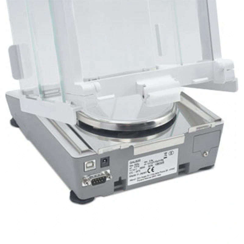 Silver and white analytical balance with a transparent glass draft shield