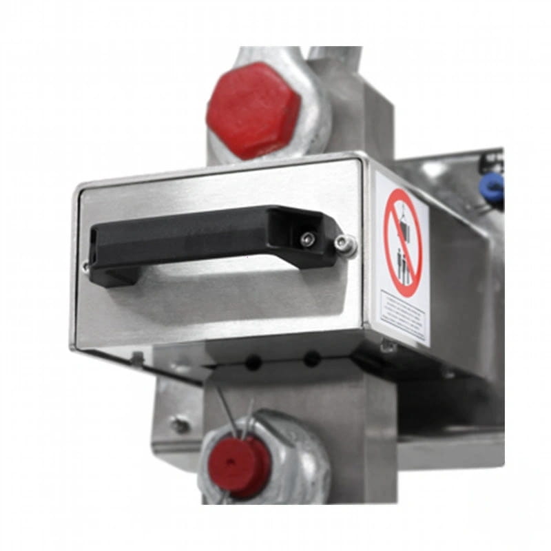 Stainless steel industrial valve with red hexagonal caps and a black handle