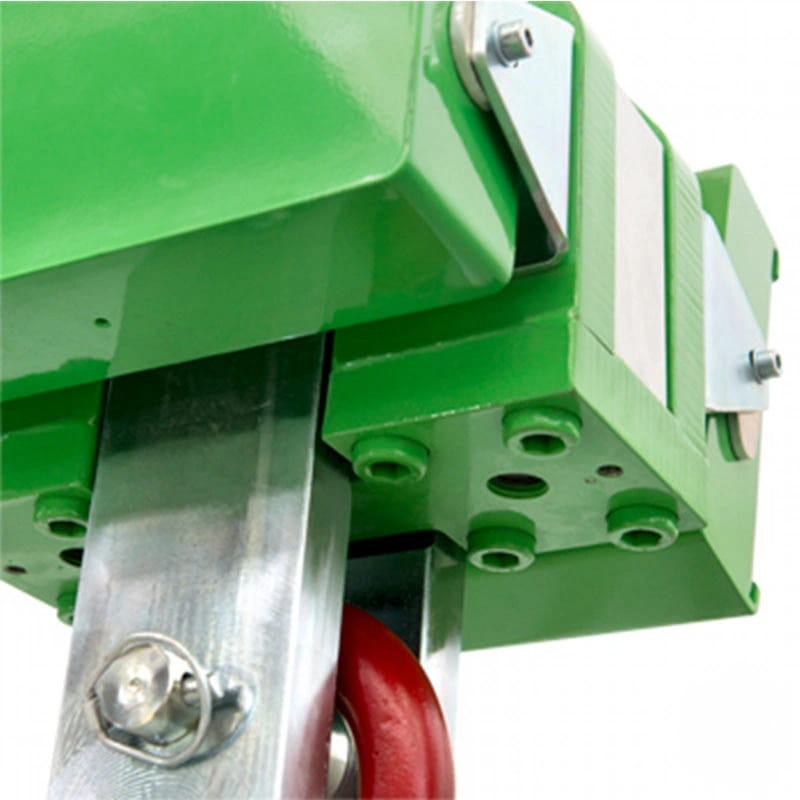 Green industrial-grade metal housing with silver bolts and a red wheel attached to its base
