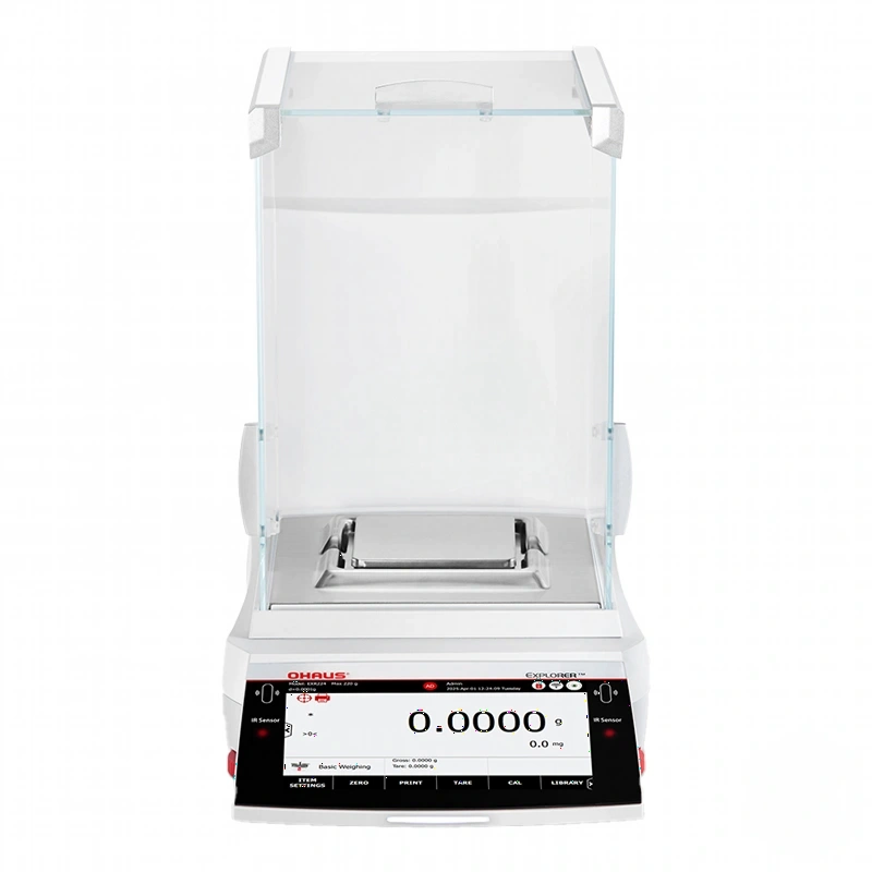 White digital analytical balance with transparent glass draft shield and black control panel displaying ’0.0000 g’