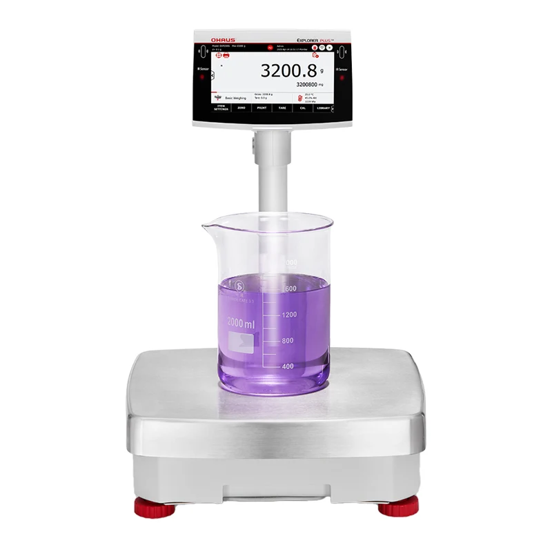 Silver ohaus top-loading analytical balance with digital display showing 3200.8 grams, featuring a transparent beaker containing purple liquid on its platform and red feet for stability