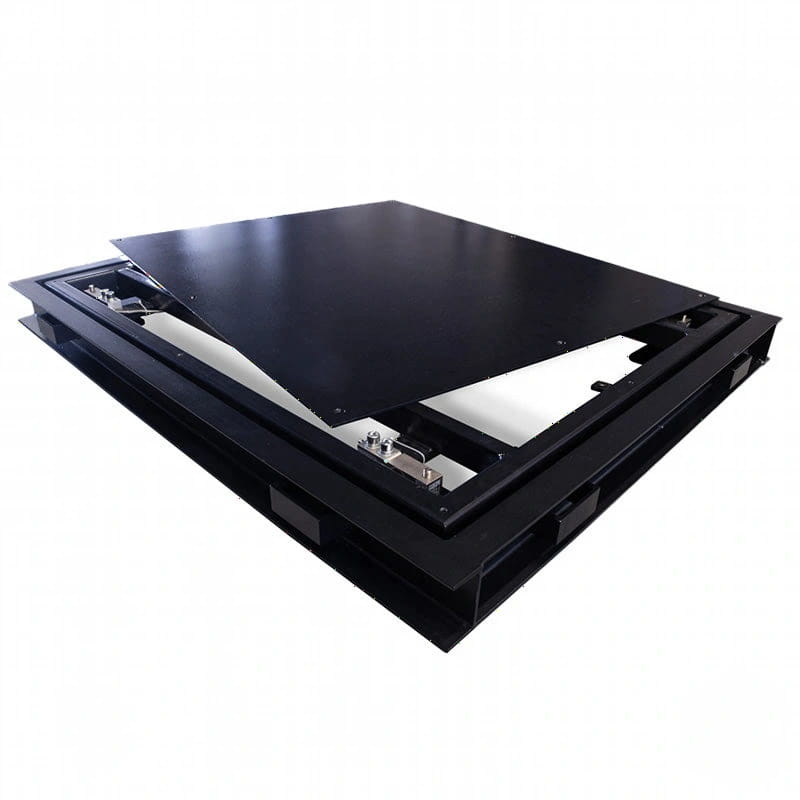 Black metal floor access panel with a hinged lid and visible internal mechanical components