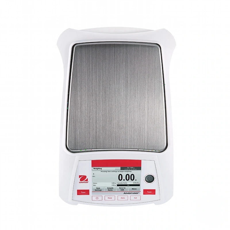 White ohaus adventurer digital scale with a brushed stainless steel weighing platform and red-accented control panel