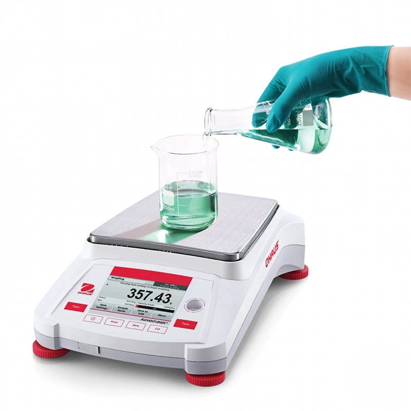 White and red ohaus adventurer digital scale with a silver weighing platform displaying 357.43 grams