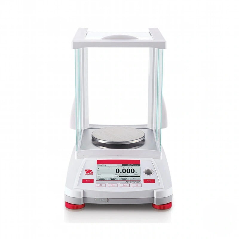 White analytical balance with a transparent glass draft shield, red-accented feet and control panel displaying ’0.000’’ on its digital screen