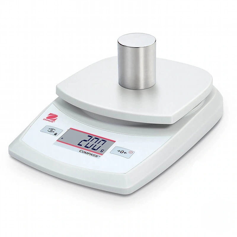 White digital scale with a silver cylindrical weight on its platform, displaying ’207 g’ on the screen