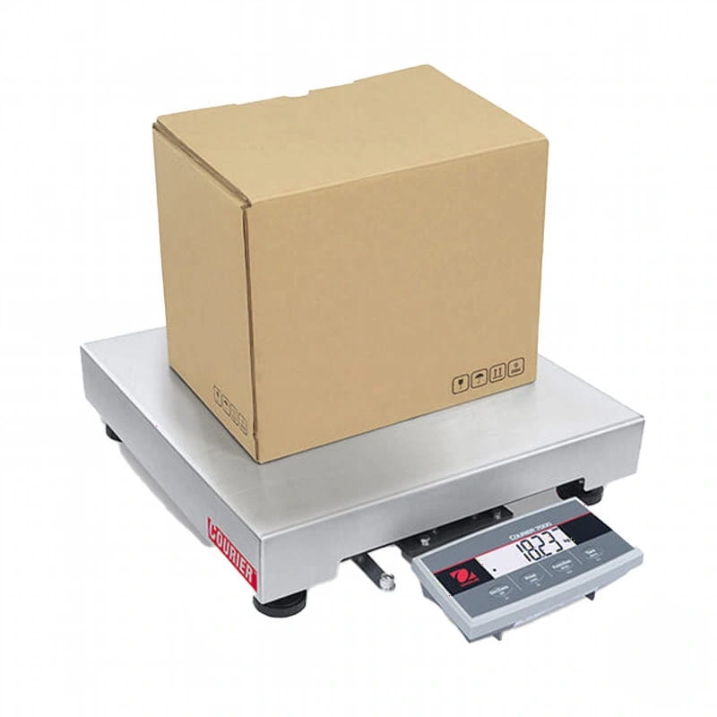 Silver digital platform scale with a brown cardboard box resting on its weighing surface