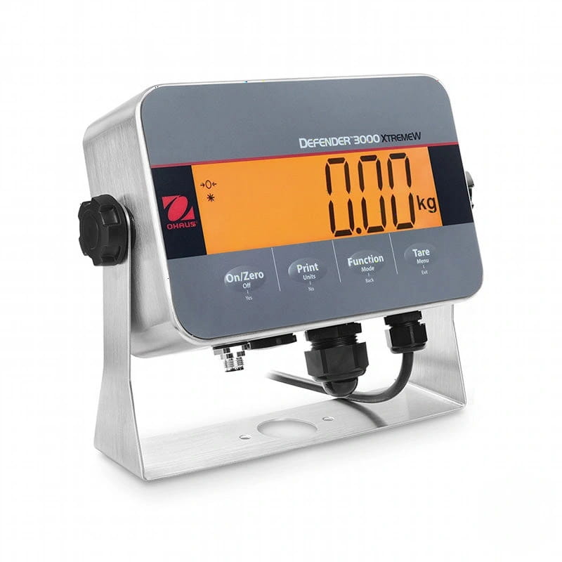 Silver stainless steel industrial scale with a digital display showing ’0.00 kg’ in orange numerals on a gray panel, featuring the ohaus defender 3000 xtremew model name and black control buttons below the screen