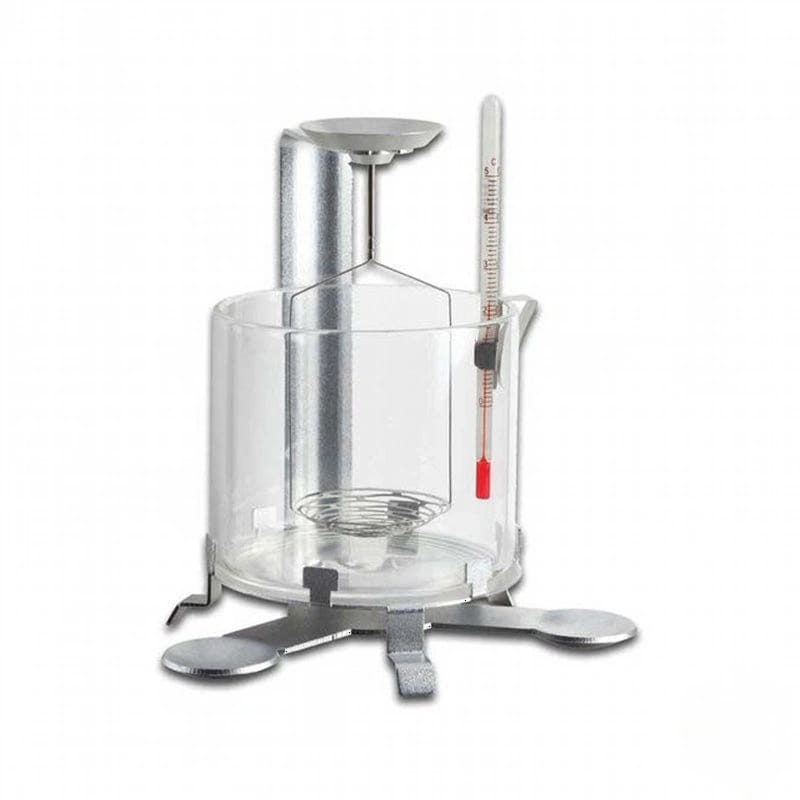 Silver-colored metal calorimeter with a clear glass outer chamber, featuring an internal wire rack and a vertical thermometer marked in degrees celsius