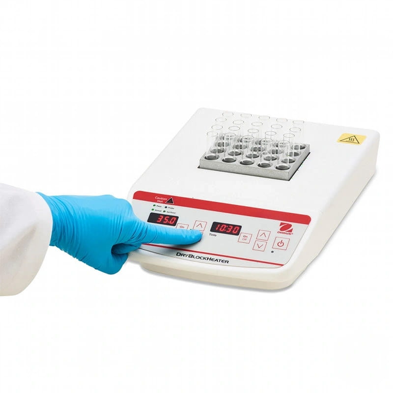 White and red digital dryblockheater with a gray tray holding clear test tubes