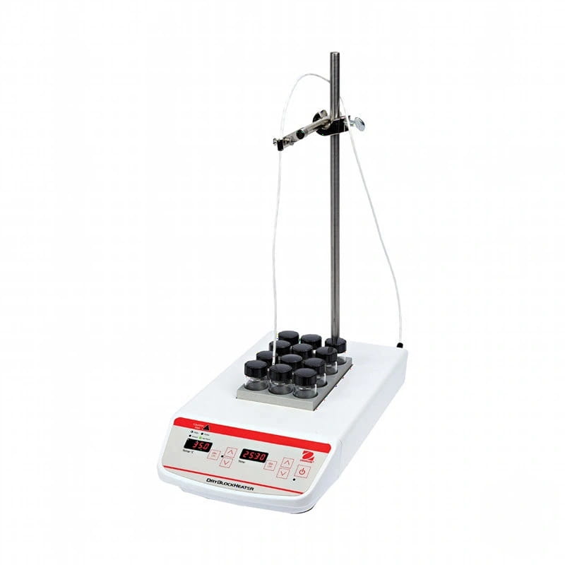 White laboratory dry bath with red control panel and black-capped glass vials arranged on a metal tray