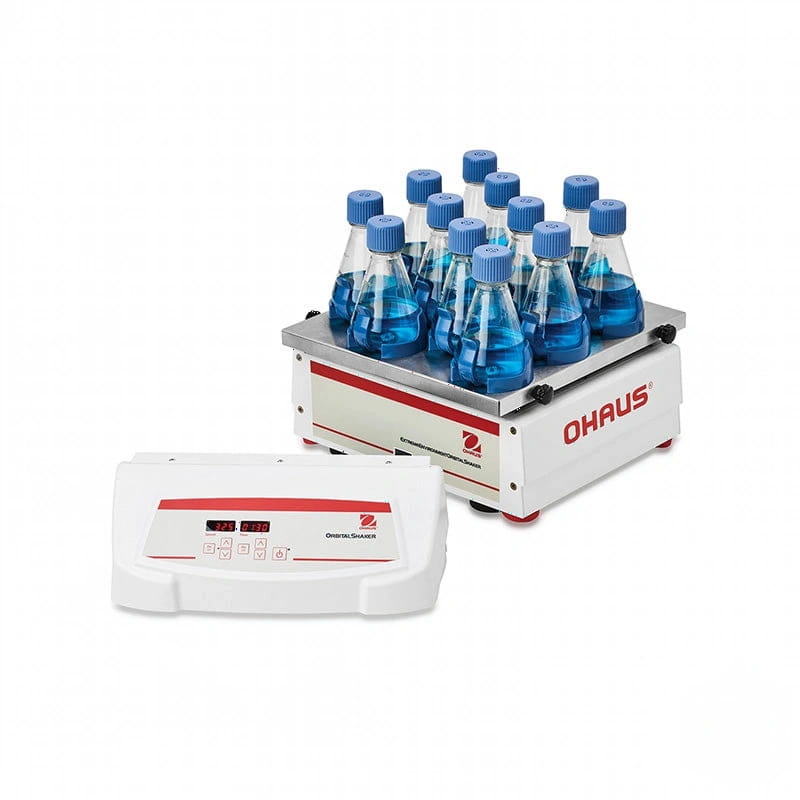 White and red ohaus orbital shaker with a digital display, holding multiple clear glass bottles capped with blue lids filled with blue liquid