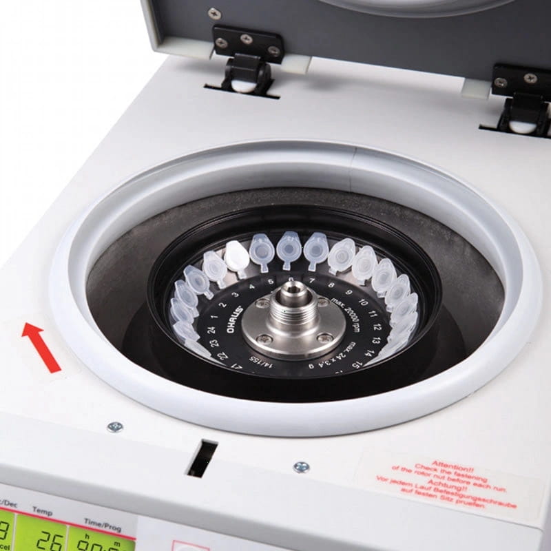 White laboratory centrifuge with a circular rotor holding clear plastic tubes, branded ’charles’ on the central hub