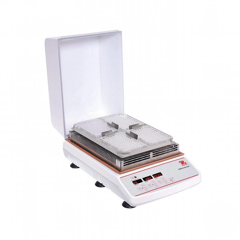 White laboratory-grade hot plate with a transparent lid, digital control panel, and two stacked metal trays for heating samples