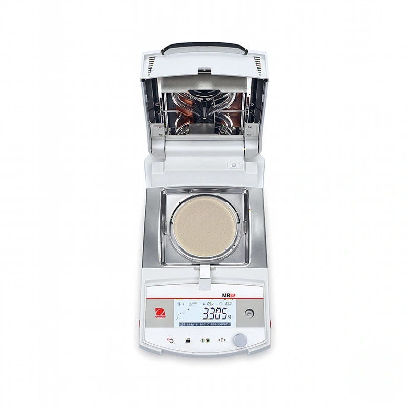 White and silver analytical balance with a digital display showing 330.5 grams, featuring an open hood revealing internal heating elements above the weighing pan