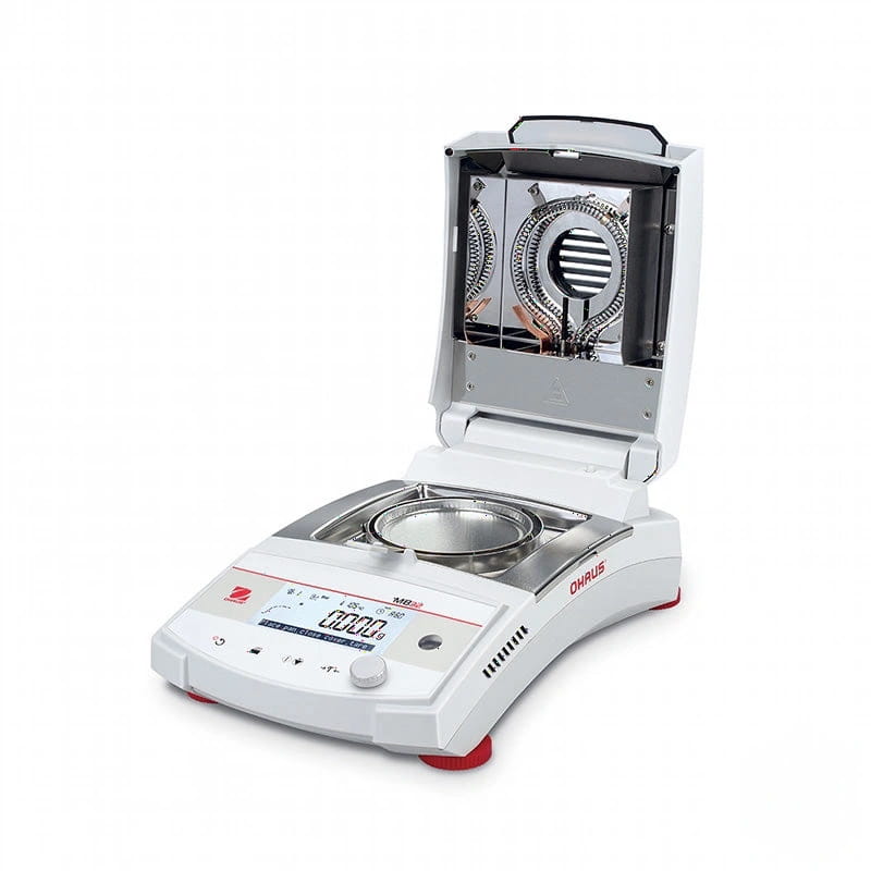 White and red analytical balance with a digital display, stainless steel weighing pan, and an open hood revealing internal heating elements
