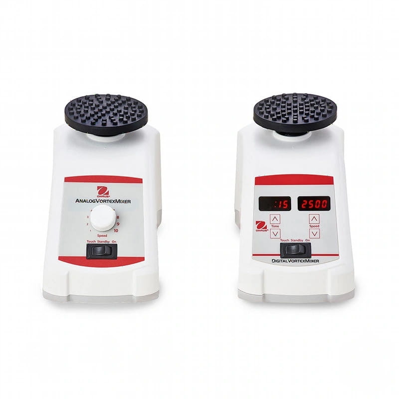 White lab equipment featuring a black textured top and red accents, with one model having an analog dial control and the other displaying digital readouts