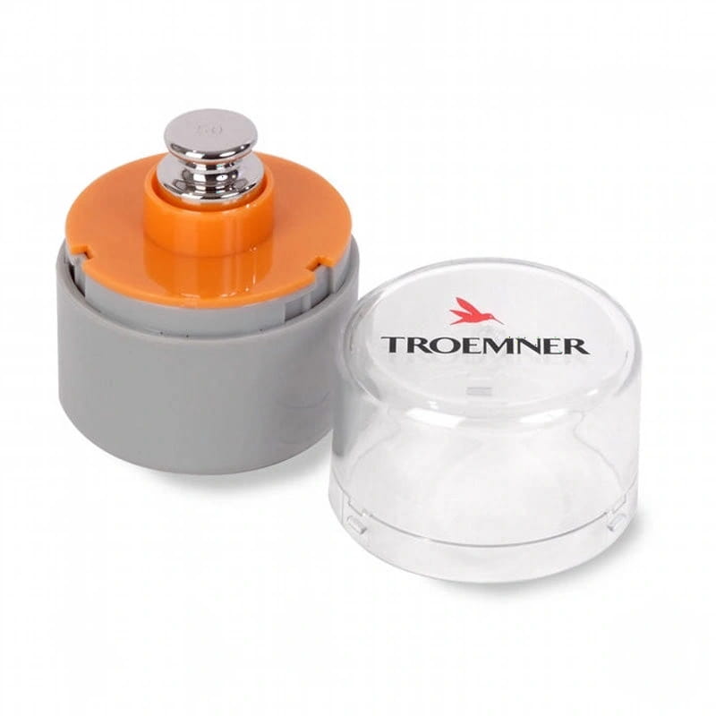 Troemner brand precision calibration weight set featuring a silver-toned metal weight housed in an orange and gray plastic casing with its clear protective lid beside it