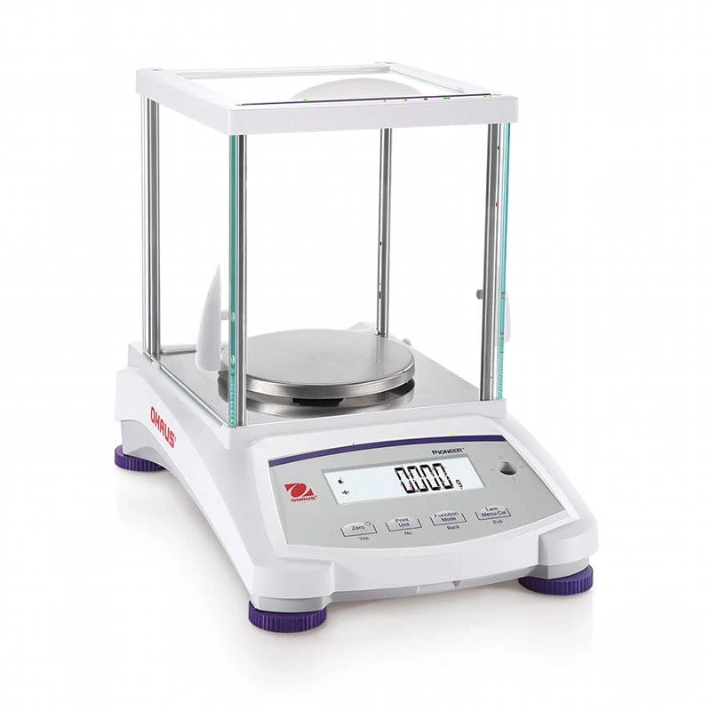 White and purple analytical balance with a glass draft shield, digital display showing zero grams, stainless steel weighing platform, and the brand name ’ohaus’ visible on its side