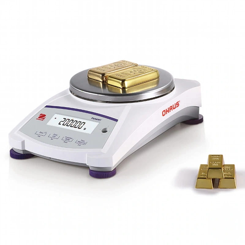 White ohaus analytical balance with a digital display showing 200.000 grams, holding two gold bars on its platform and additional gold bars arranged nearby