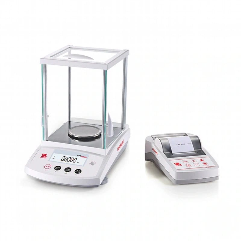 White analytical balance with glass draft shield and digital display next to a matching printer unit