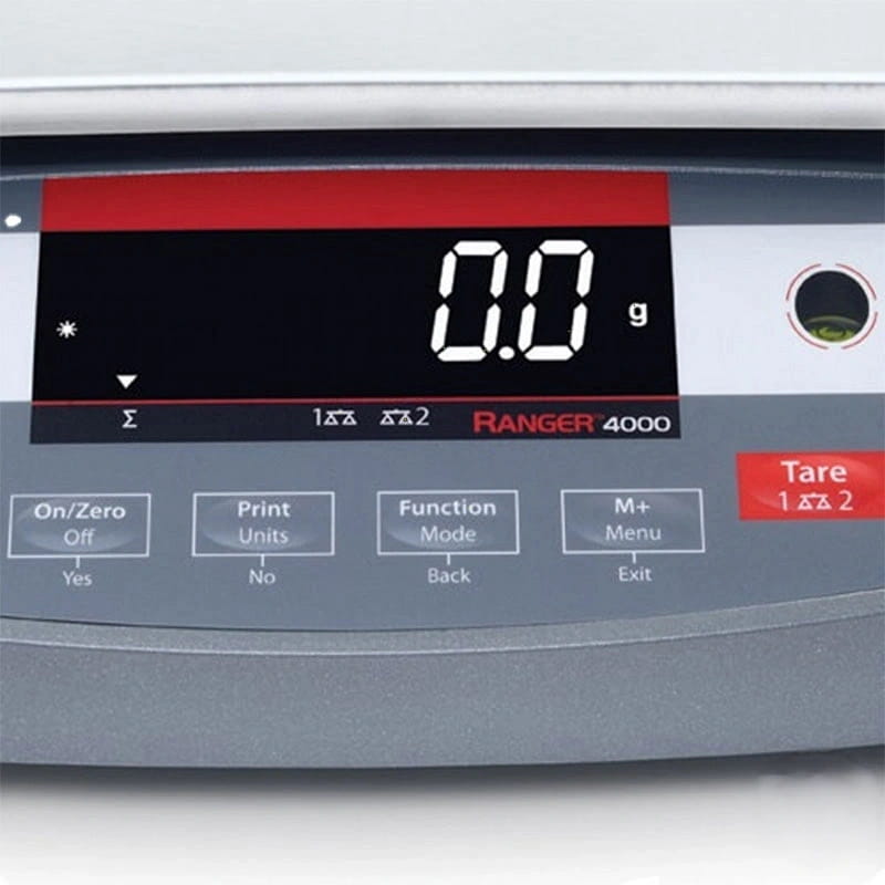 Gray digital scale with a red and black display showing ’0.0 g’ and labeled ’ranger 4000’’