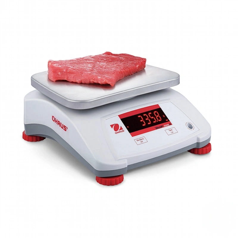 White and red ohaus valor 2000 digital scale with a silver weighing platform displaying a piece of raw meat