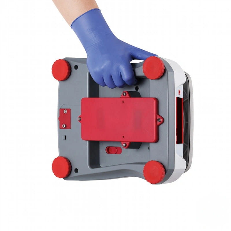 Gray and red plastic floor cleaning machine with four red circular feet