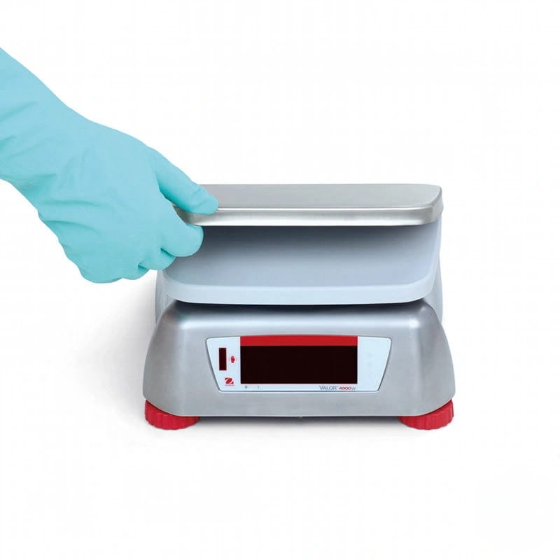 Silver digital scale with red accents and a white weighing platform, featuring the brand name ’sartorius’ on its front panel