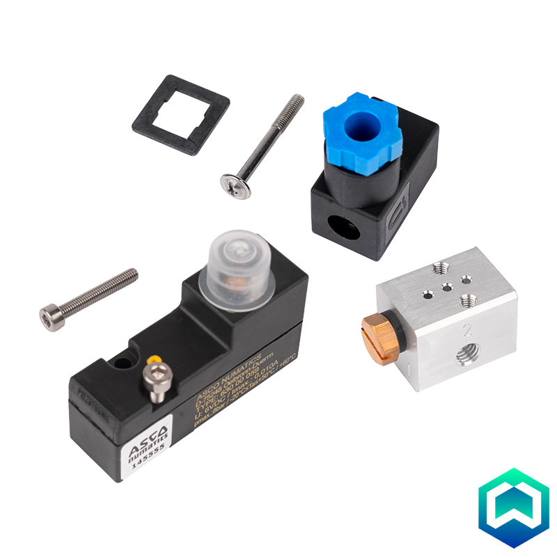 A set of industrial hydraulic components, including a black ASMA solenoid valve with a clear cap, a black and blue connector, a silver metal block, and mounting hardware, arranged on a white background. 3/2-way, Piezo-pilot, superposed, normally closed (NC) poppet valve. Compatible with DFWIECEX digital outputs. Conforms to ATEX directive and IECEx certification scheme. Degree of protection: Gas: II 1G Ex ia IIC T6 or T4 Ga and Dust: II 1D Ex ia IIIC T135°C.
