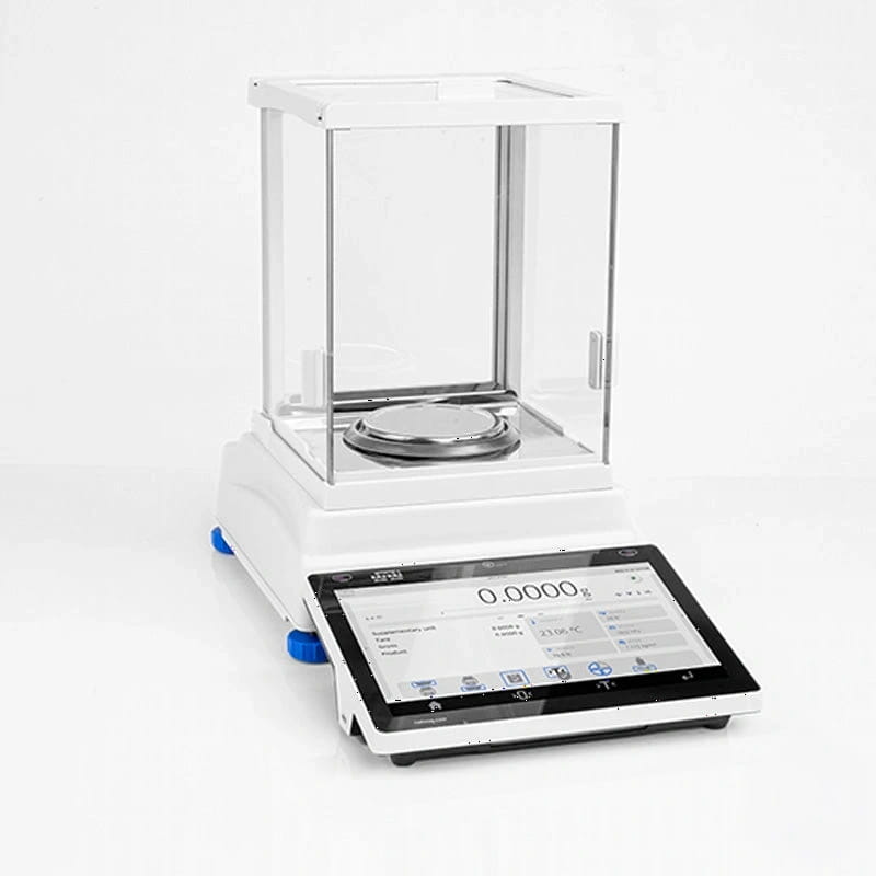 White analytical balance with a transparent glass draft shield and digital touchscreen display