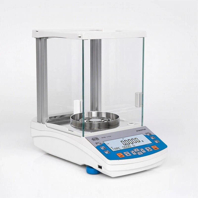 White analytical balance with a transparent glass draft shield, stainless steel weighing pan, and blue control panel displaying digital readouts