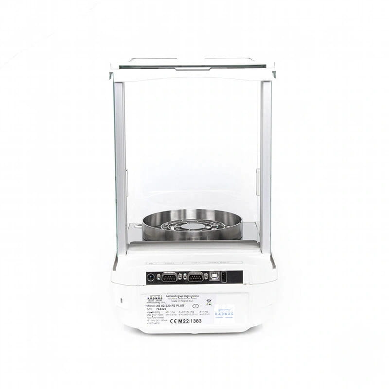White analytical balance with a clear glass enclosure and stainless steel weighing pan