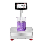 Silver ohaus top-loading analytical balance with digital display showing 3200.8 grams, featuring a transparent beaker containing purple liquid on its platform and red feet for stability
