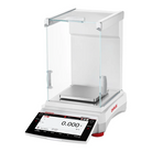 White ohaus analytical balance with transparent glass draft shield and digital display showing zeroed weight reading